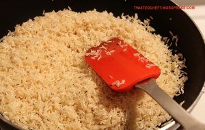 Rice being sauteed for shrimp biryani